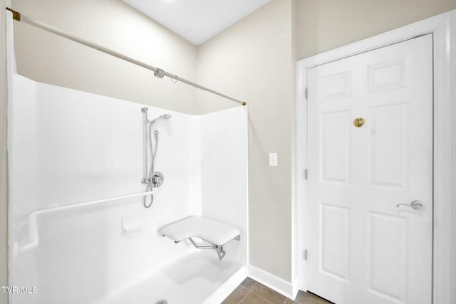 bathroom featuring a shower and hardwood / wood-style flooring