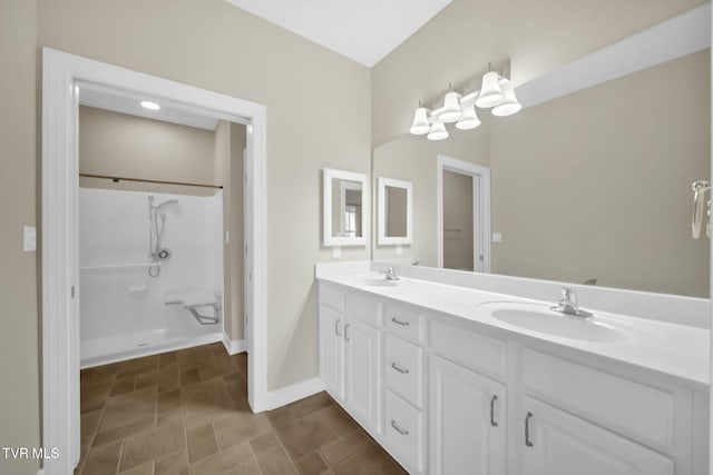 bathroom featuring vanity and a shower