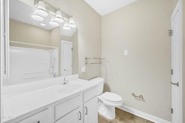 bathroom featuring vanity, toilet, tile patterned flooring, and walk in shower