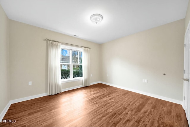 empty room featuring wood-type flooring