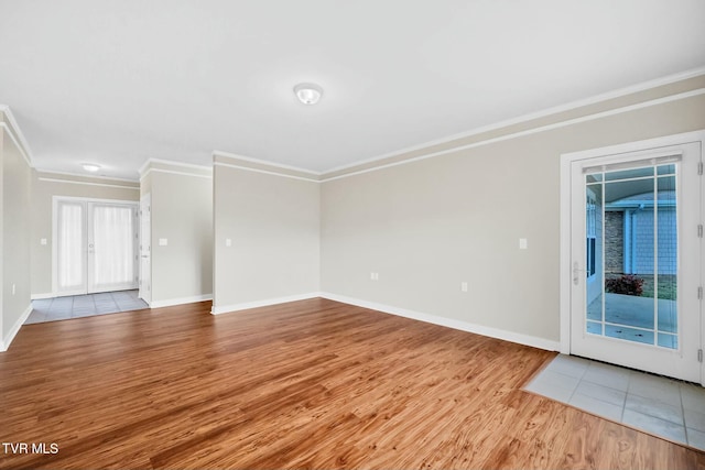 unfurnished living room with french doors, light wood-type flooring, and ornamental molding