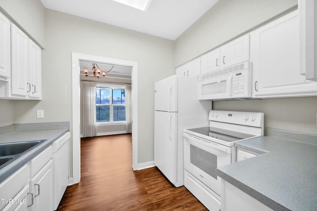 kitchen featuring white cabinets, a notable chandelier, dark hardwood / wood-style floors, and white appliances