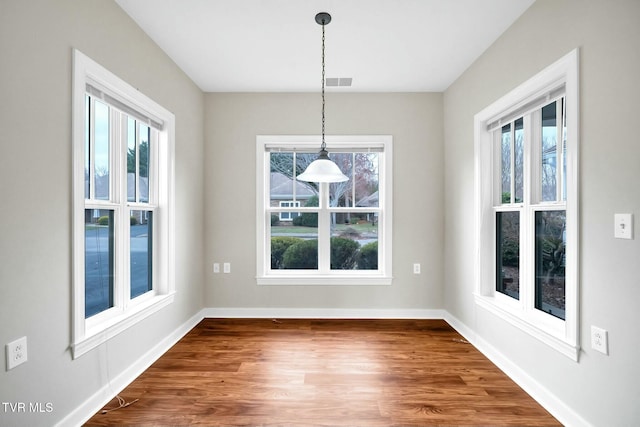 unfurnished dining area featuring a wealth of natural light and hardwood / wood-style flooring