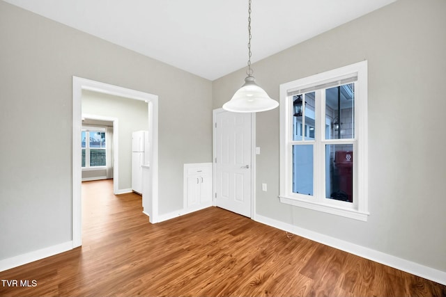 unfurnished dining area featuring hardwood / wood-style flooring