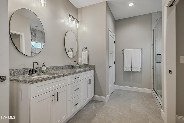 bathroom with tile patterned flooring, vanity, and a shower with shower door