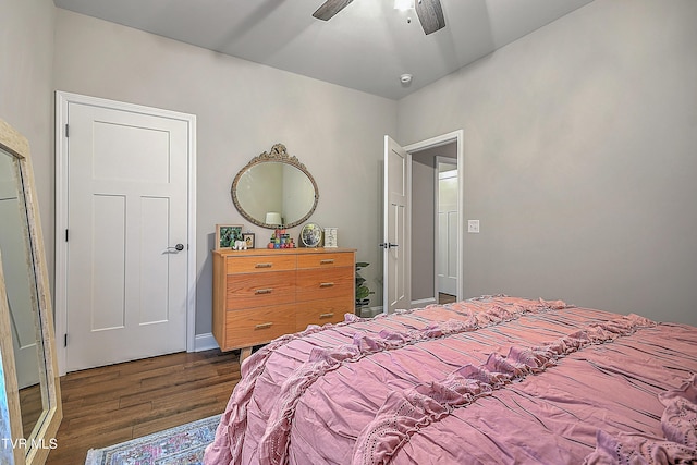 bedroom with dark hardwood / wood-style floors and ceiling fan