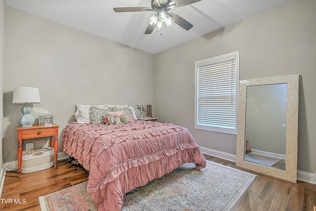 bedroom with hardwood / wood-style floors and ceiling fan