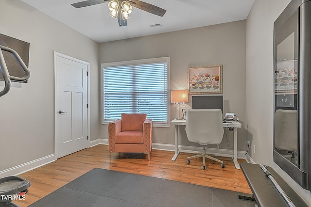 home office with ceiling fan and hardwood / wood-style floors