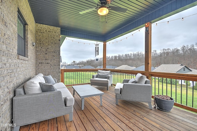 deck featuring a lawn, ceiling fan, and an outdoor hangout area