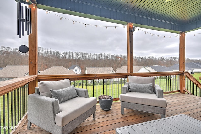 wooden terrace with a lawn