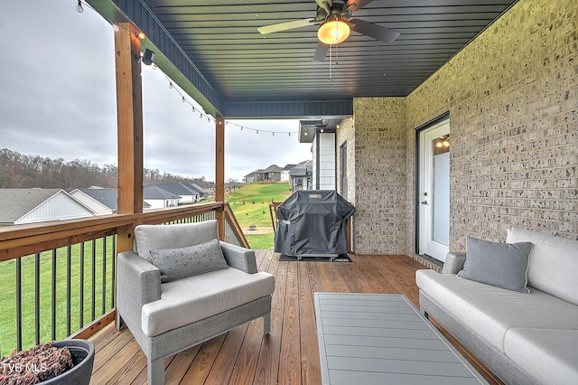 wooden terrace featuring a yard, area for grilling, and ceiling fan