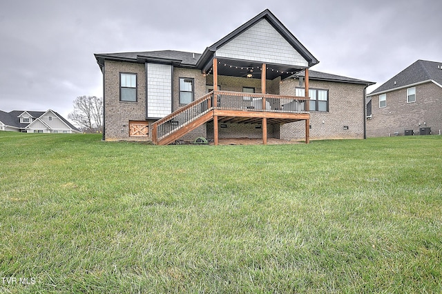 rear view of house featuring a lawn, ceiling fan, central air condition unit, and a wooden deck