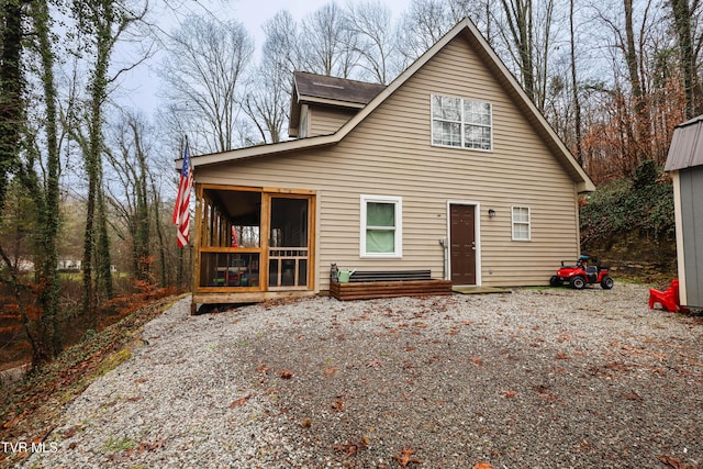 rear view of property with a sunroom