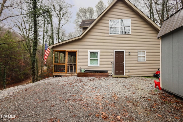 rear view of house with a sunroom