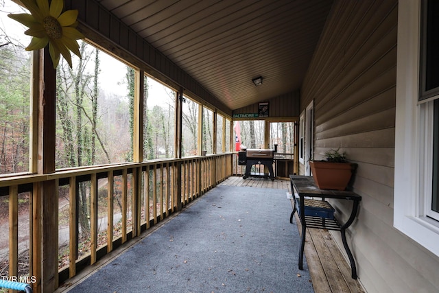 sunroom featuring ceiling fan, wooden ceiling, and vaulted ceiling