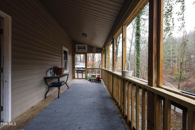 unfurnished sunroom with lofted ceiling