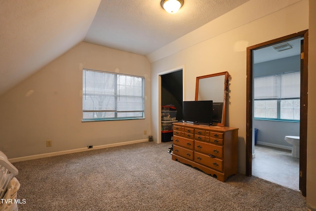 bedroom featuring dark colored carpet, a textured ceiling, and vaulted ceiling