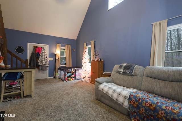 carpeted living room featuring high vaulted ceiling