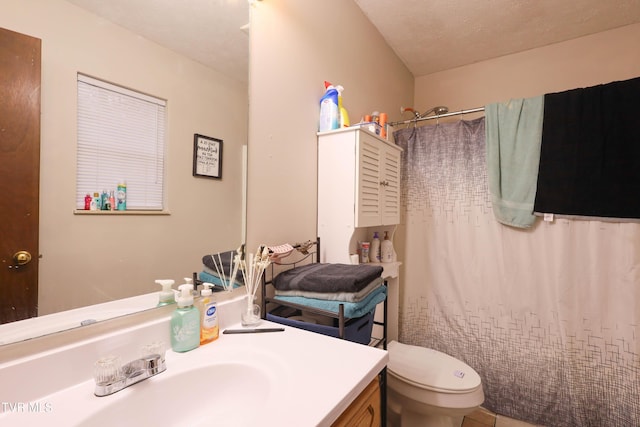 bathroom with vanity, toilet, and curtained shower