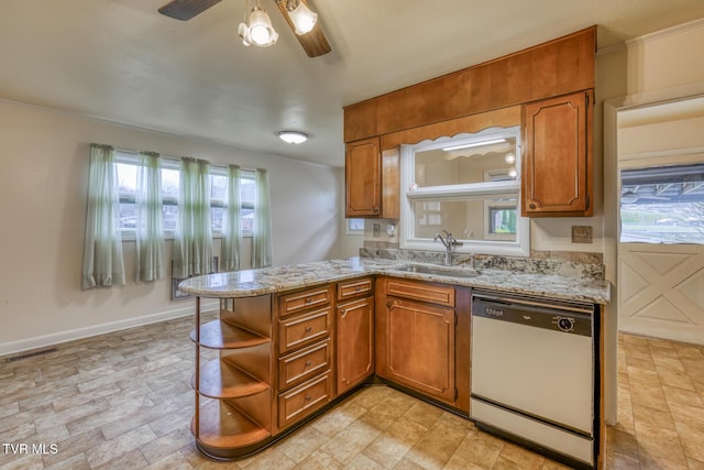 kitchen featuring sink, ceiling fan, light stone countertops, dishwashing machine, and kitchen peninsula