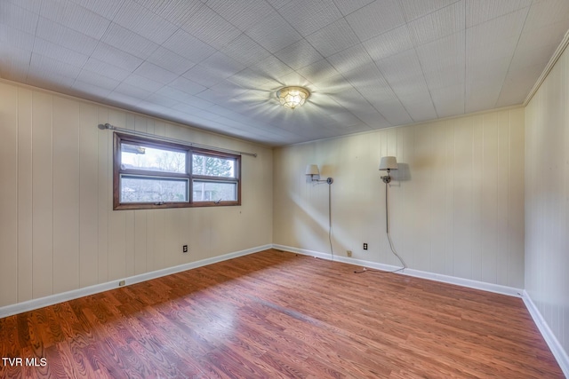 spare room with hardwood / wood-style flooring