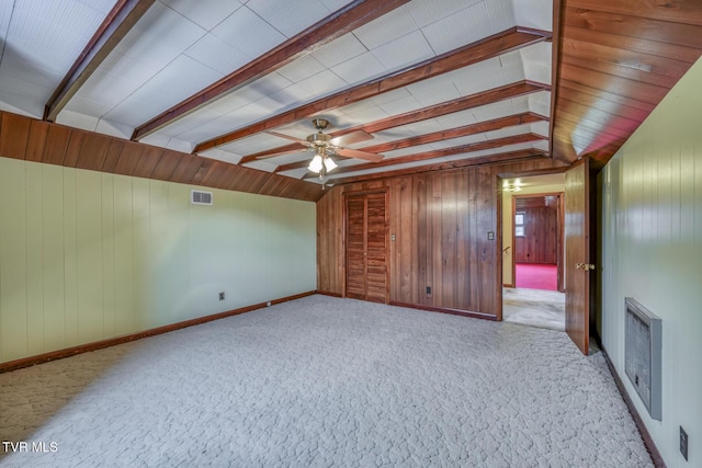 interior space with light colored carpet, ceiling fan, lofted ceiling, and wood walls