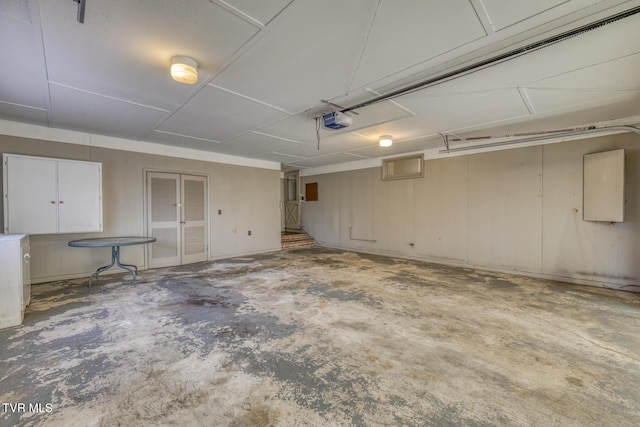 garage featuring electric panel and a garage door opener