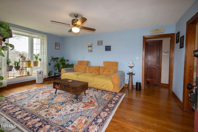 living room featuring ceiling fan and hardwood / wood-style flooring