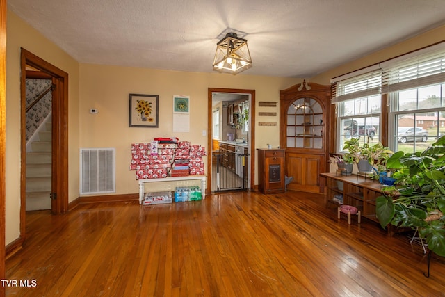 miscellaneous room featuring wood-type flooring and a textured ceiling