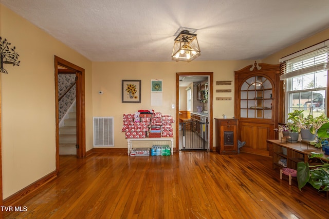 interior space with hardwood / wood-style floors and a textured ceiling