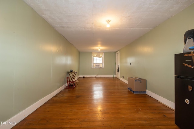 empty room with hardwood / wood-style flooring and cooling unit