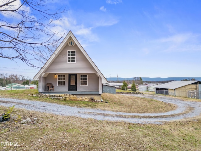 view of front facade with a mountain view and covered porch