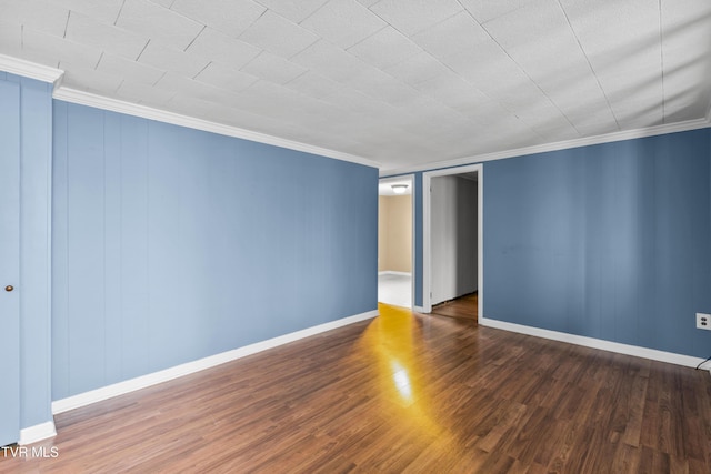 spare room with crown molding and dark hardwood / wood-style floors