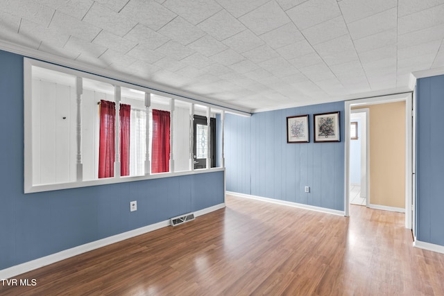 spare room featuring wood-type flooring