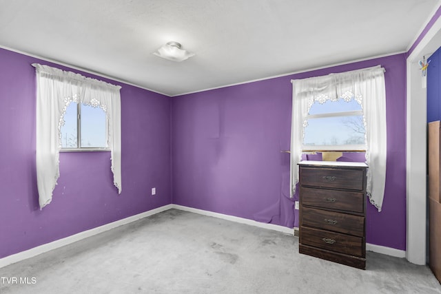 unfurnished room featuring light colored carpet and a healthy amount of sunlight