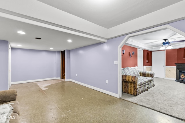 unfurnished living room with a fireplace and ceiling fan