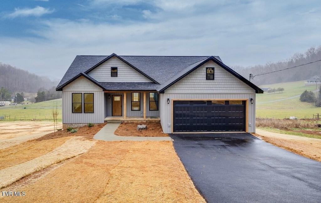 modern farmhouse style home with a porch and a garage