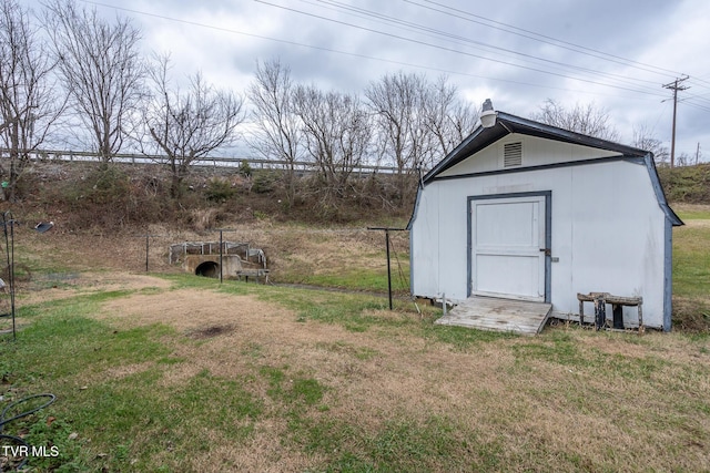 view of outbuilding featuring a lawn