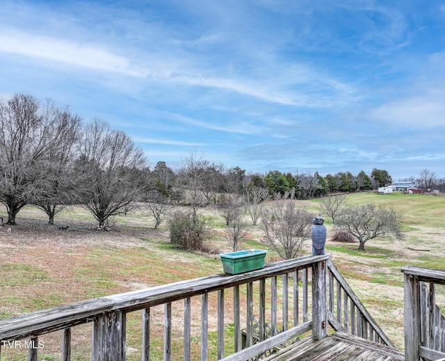 wooden deck featuring a rural view