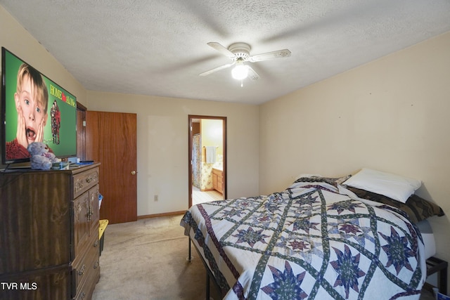 carpeted bedroom featuring a textured ceiling, ceiling fan, and ensuite bathroom