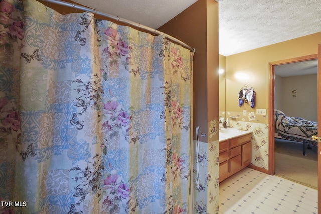 bathroom featuring vanity, a textured ceiling, and a shower with shower curtain