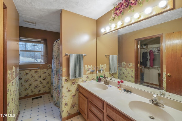 bathroom featuring vanity and a textured ceiling