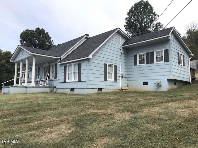 exterior space featuring crawl space, covered porch, and a lawn