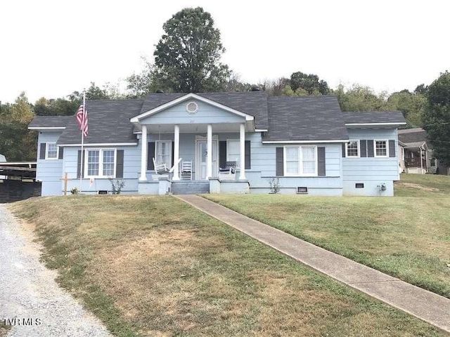 view of front of home featuring covered porch, a front lawn, and crawl space