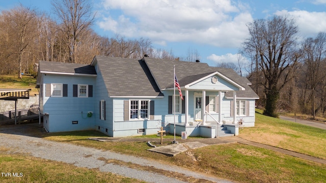 view of front of property with a shingled roof, a front yard, and crawl space