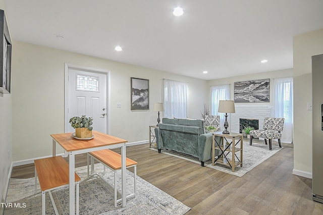 living room with hardwood / wood-style flooring and a fireplace