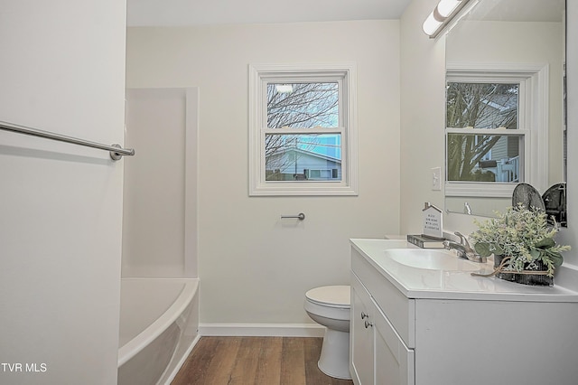 bathroom featuring wood-type flooring, vanity, and toilet