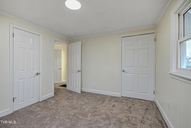 unfurnished bedroom featuring light carpet and ornamental molding