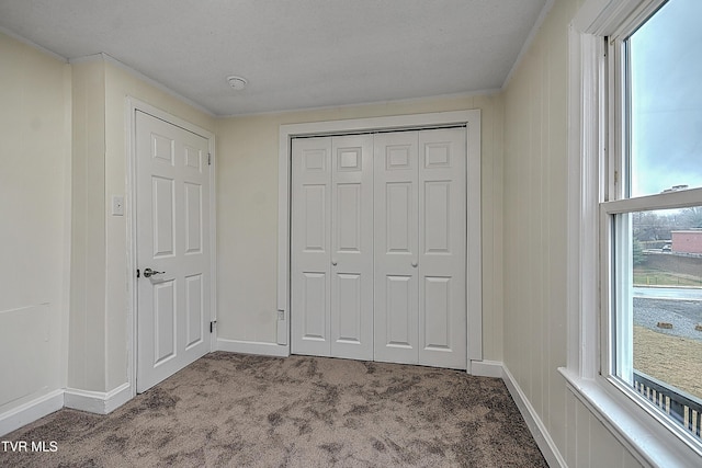 unfurnished bedroom with light carpet and a closet