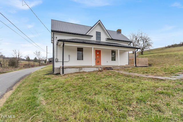 view of front of house with covered porch and a front yard